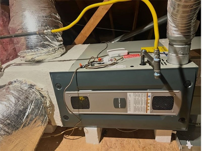 Gauges connected to an attic air handler during a Climate Mechanical diagnosis